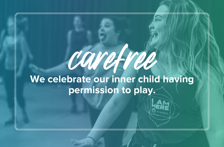 carefree: we celebrate our inner child having permission to play.  Two women dancing, the one in the forefront is laughing and the one behind is sticking their tongue out in silliness.
